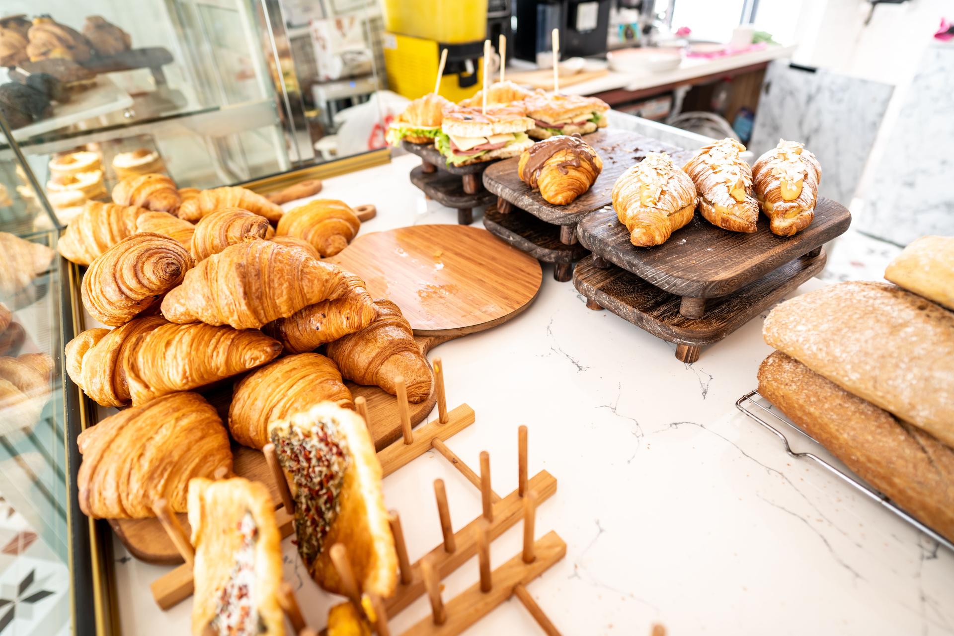 croissants and pastry are in showcase at pastry shop horizontal small business still